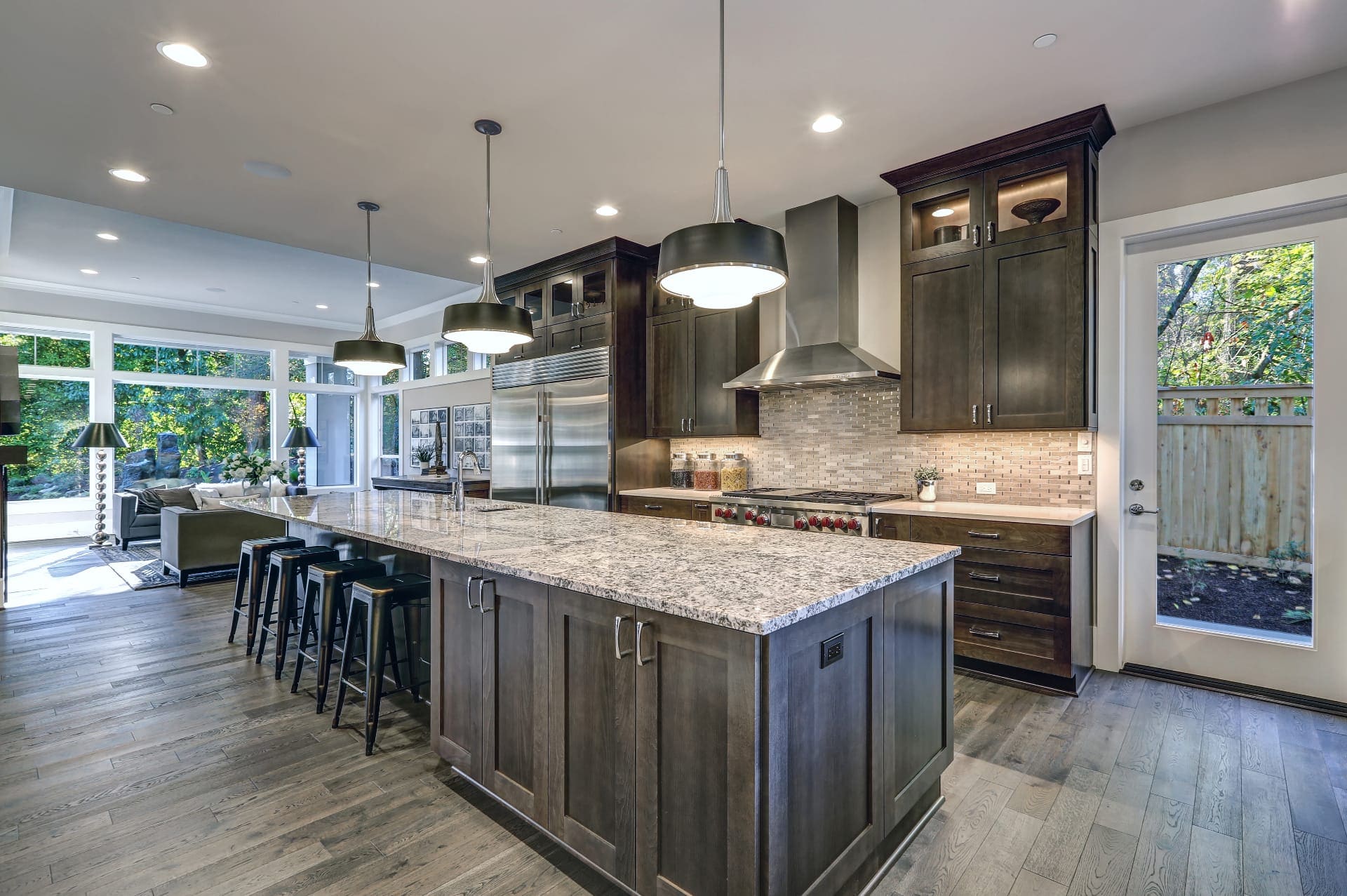 Luxury white kitchen remodel with marble island, custom cabinetry, and pendant lighting by Icon Remodeling